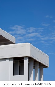 Low Angle View Of Rectangle Porch Columns On Terrace Of White Modern House Building Against Blue Sky In Vertical Frame