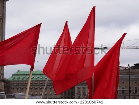 Low angle view of red flags against sky