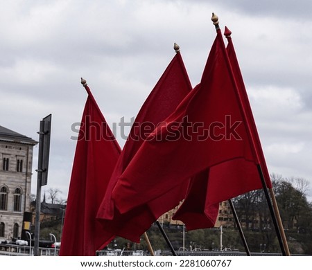 Low angle view of red flags against sky