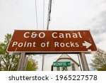 Low angle view of the road sign showing the direction of the famous historic C and O ( Chesapeake and Ohio) canal in Point of Rocks, a small town in the Frederick County of Maryland