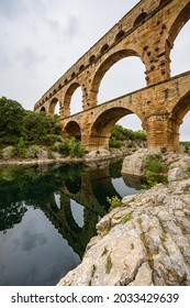 Low Angle View Of A Roman Empire Aqueduct, Pont Du Gard In France. Ancient Civilisation Engineering For Water Supply.