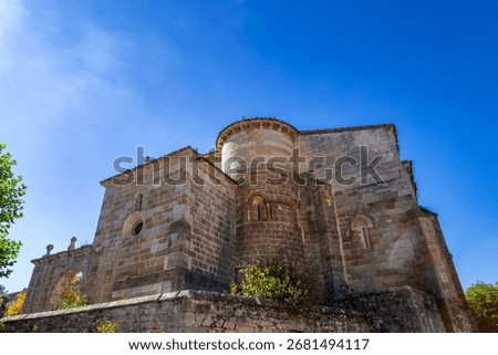 Low angle view of the Romanesque apse and transept of the monumental Church of the Assumption in Barrio de Santa María, Spain