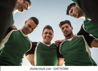 Low angle view of rugby players standing against clear sky. Rugby team in huddle after the match. - Powered by Shutterstock