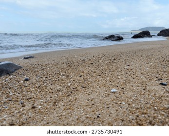Low Angle View of Sandy Beach with Ocean Waves