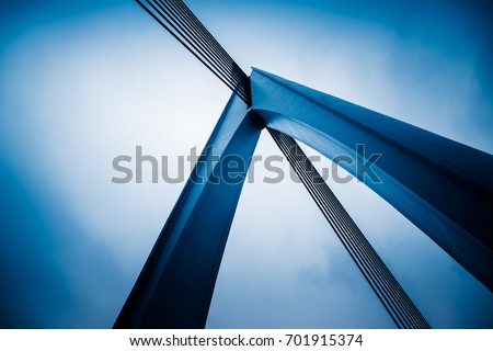 low angle view of silver steel bridge against sky.
