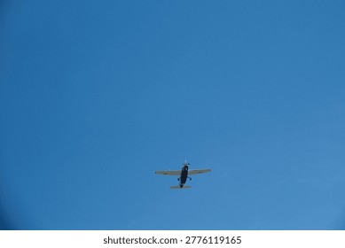 Low Angle View of a Single-Propeller Plane Flying in Clear Blue Sky