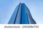 Low angle view of skyscraper with glass window and clear blue sky background for business and finance concept