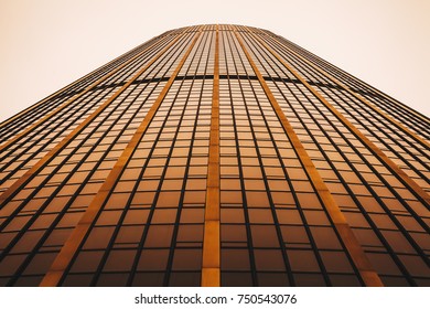 Low angle view skyscraper reflective glassy walls and windows background. Modern architecture pattern concept.