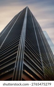 Low angle view of skyscraper under dark sky