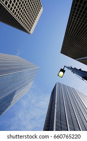 Low Angle View Of Skyscraper Under Blue Sky With Street Lamp