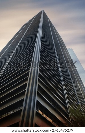 Low angle view of skyscraper under dark sky