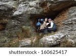 Low angle view of a smiling young couple on rock while on a hike
