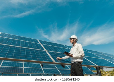 Low angle view of solar farm(solar panel) with engineers check the operation of the system, Alternative energy to conserve the world's energy, Photovoltaic module idea for clean energy production. - Shutterstock ID 1620691240