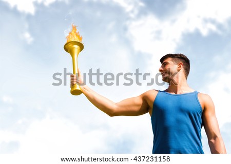 Low angle view of sportsman holding a cup against blue sky