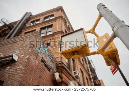 low angle view of street pole with traffic lights near brick buildings on street in new york city