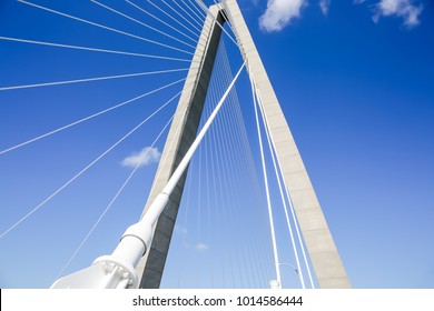 Low angle view of suspension bridge in SC. Summer day with blue skies and modern architecture.