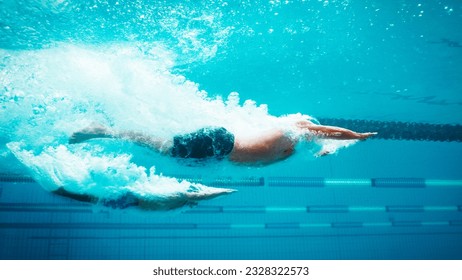 Low angle view swimmers racing in pool - Powered by Shutterstock