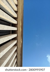 Low angle view of a tall architectural column against a bright blue sky