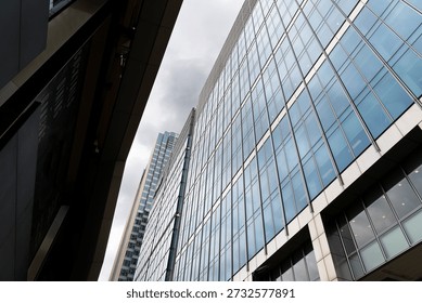 Low angle view of tall structured architecture in London, Canary Wharf on Crossrail Place