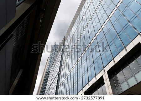 Low angle view of tall structured architecture in London, Canary Wharf on Crossrail Place
