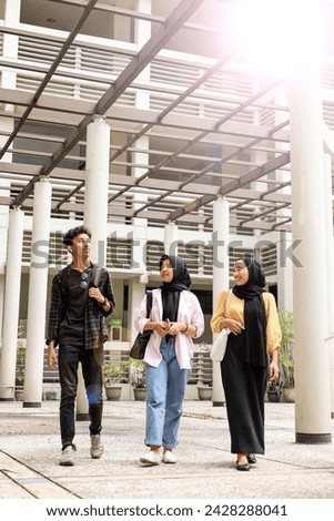 Low Angle View of Three Asian University Students Walking on Campus