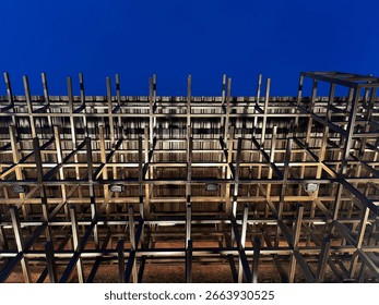 Low angle view of three-dimensional facade frame with lighting at night