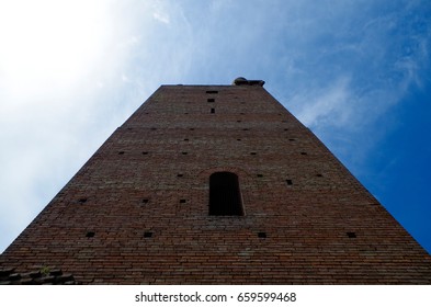 Low angle view of tower against cloudy sky during spring in San Miniato, Italy. 