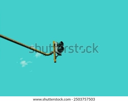 Low angle view of traffic light and metal pole against the sky