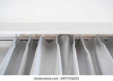 Low angle view of tulle hung on a white curtain rod. Close up shot of gray window blinds in bedroom. Home decor for comfortable and cozy living in apartment, copy space - Powered by Shutterstock