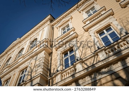 Low angle view of a typical Austro-Hungarian facade in Zemun, Belgrade, Serbia, highlighting ornate plasterwork, tall windows and historic urban architecture in one of the city's older districts.