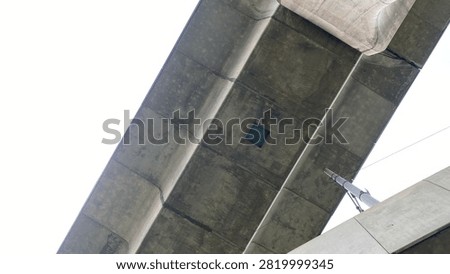 Low angle view under concrete flyover bridge structure