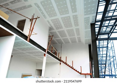 Low Angle View Of Unfinished Internal Modern Office Building Structure With Materials In Construction Site.