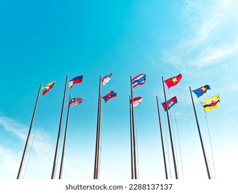 Low Angle View of Waving Flags of ASEAN Countries Against Blue Sky