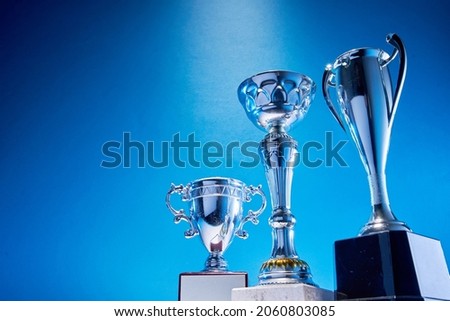 low angle view of winning trophy against blue background