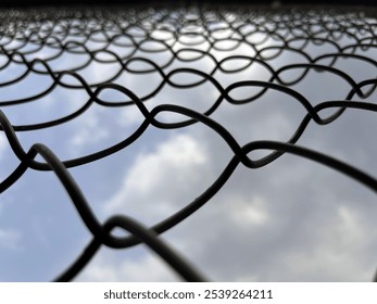 Low angle view of a wire fence with shallow depth of focus - Powered by Shutterstock