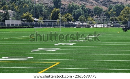 Low angle view of yard markers on American football field.