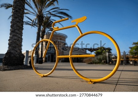Low angle view of a yellow bicycle rack in the shape of a ten speed bike in a shopping area