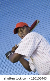 Low angle view of a young baseball player batting against net - Shutterstock ID 110103443