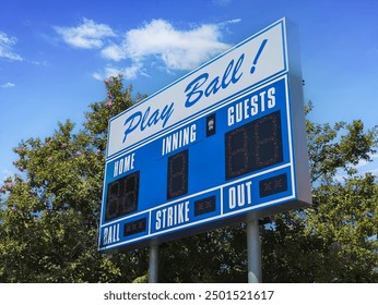 Low angled view of an electronic scoreboard at a youth baseball field. - Powered by Shutterstock