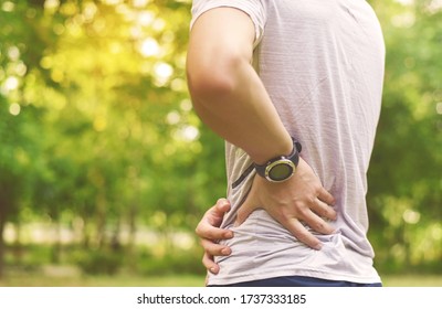 Low Back Pain, Close Up Of Young Man Has Pain At Back And Hip, Outdoor Exercise For Pain Management Concept