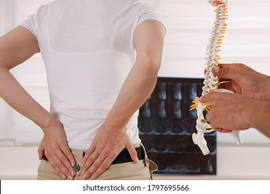 Low Back Pain ,pinched Nerve. Doctor Chiropractor Explains Causes Of Back Pain To Female Patient