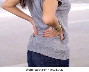 Low Back Pain. Woman Suffering From Painful Lumbago Or Kidney Illness.