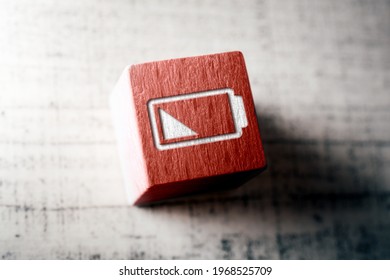 Low Battery Icon On Red Wooden Block On A Table - Shutterstock ID 1968525709