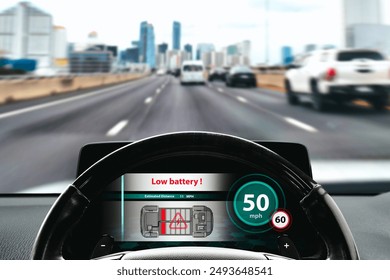 Low battery warning on the screen of an EV electric car , Electric car with low estimated range driving on the highway at daytime , EV electric car technology concept. - Powered by Shutterstock