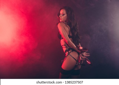 Low below angle profile side view portrait of stunning magnificent attractive sporty thin fit form shape line wavy-haired lady wearing swordbelt posing teasing touching hair isolated on black red 