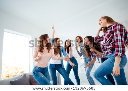 Low below angle view of nice lovely shine charming attractive cheerful glad optimistic girls buddy fellow wearing casual having fun day in light white interior room house indoors