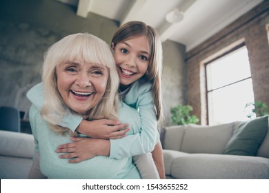 Low Below Angle View Photo Of Two Best Friends People Cute Aged Granny Small Grandchild Girl Hug Piggyback Playing Funny Game Spend Weekend Together House Indoors