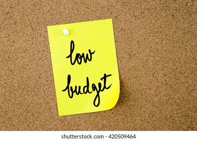 Low Budget Written On Yellow Paper Note Pinned On Cork Board With White Thumbtacks, Copy Space Available