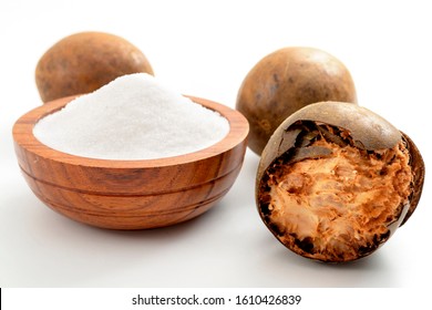 Low calorie alternative to sugar and natural remedy for inflammatory disease and arthritis conceptual idea with Luo Han Guo or Monk fruit and bowl of powder sweetener isolated on white background