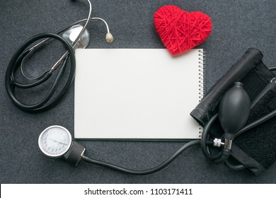 Low carb, low carb high fat (LCHF), Keto, ketogenic diet mockup with white notebook, red thread heart with tonometer on grey table. Benefits, What Eat, How to Reach Ketosis, Optimal Macros